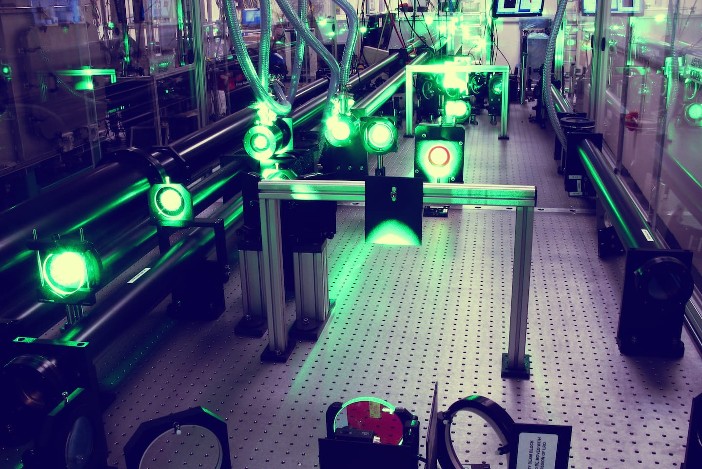 The Gemini amplifier. The image shows several green lights in a dark room on a metal floor (Image: STFC/Clear Laser Facility)